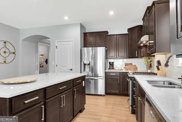 a kitchen with a sink stainless steel appliances and cabinets