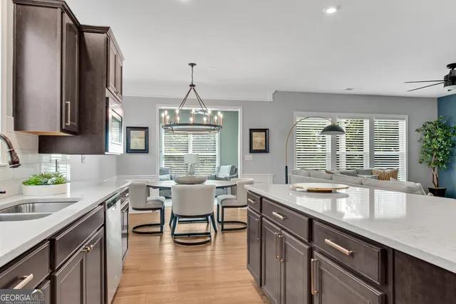 a open kitchen with a sink dining table and chairs