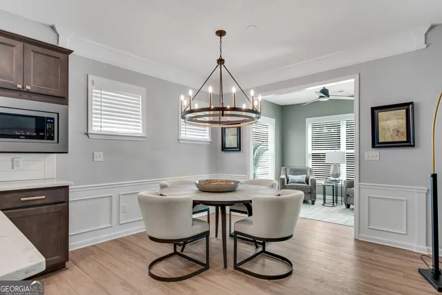 a dining room with furniture a window and wooden floor