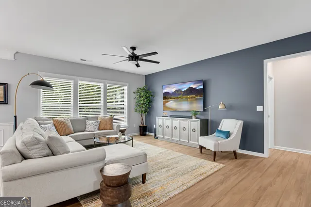 a living room with furniture and a flat screen tv