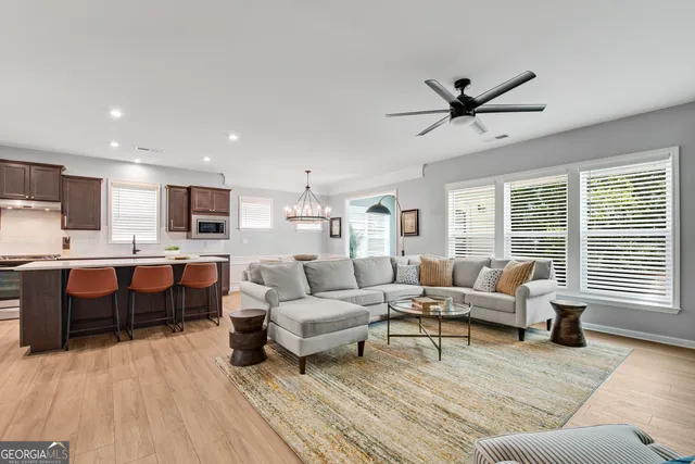 a living room with furniture and a wooden floor
