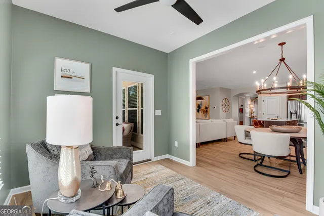 a living room with furniture a dining table and a piano