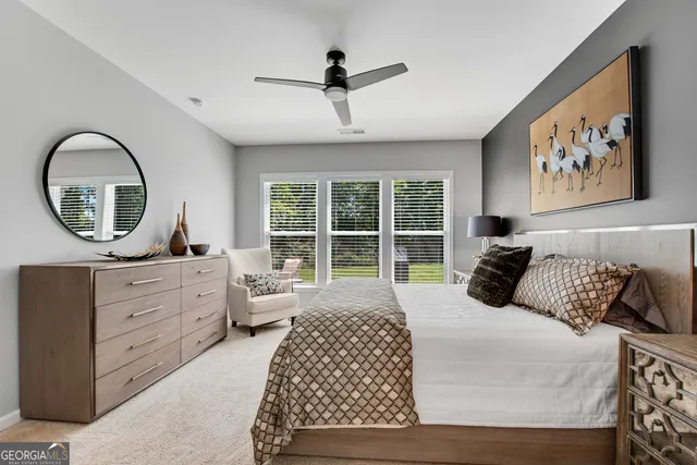 a bedroom with a large bed and a large window