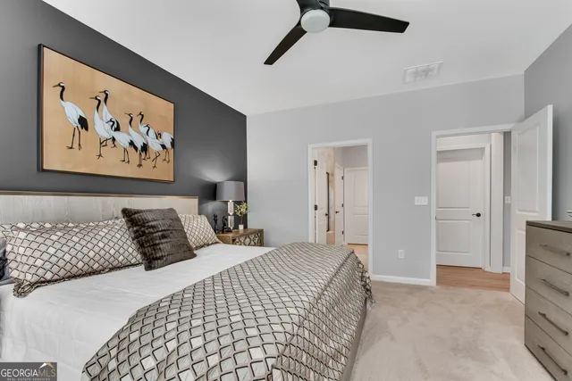 a bedroom with a large bed and a chandelier