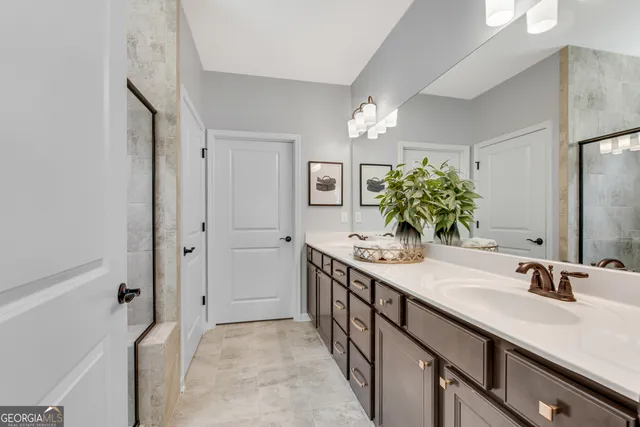 a bathroom with a double vanity sink and a mirror