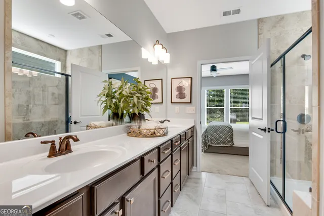 a bathroom with a tub sink and mirror