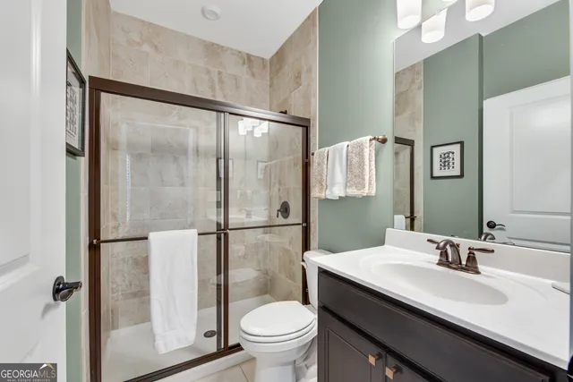 a bathroom with a sink toilet and a mirror