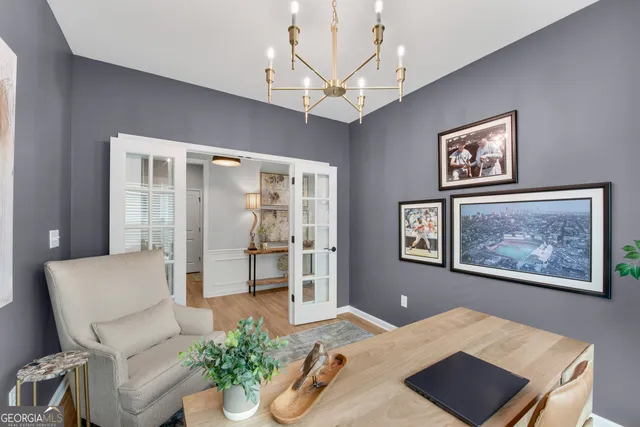 a living room with furniture flowerpot and a chandelier