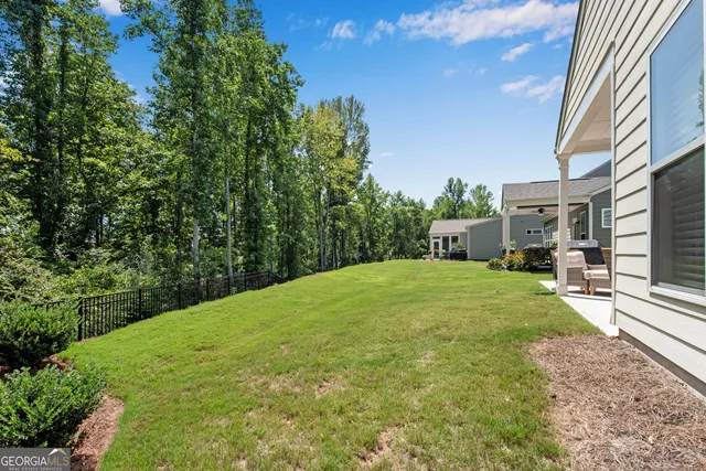 a view of a house with a yard and sitting area