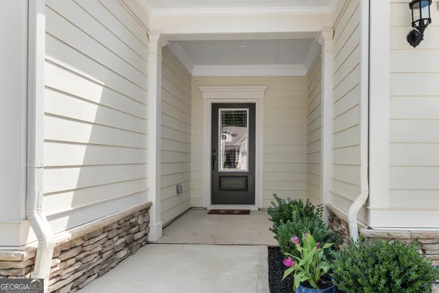 a view of house with a potted plant and a window