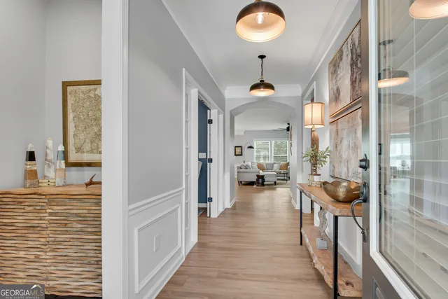 a view of a hallway and a livingroom with furniture
