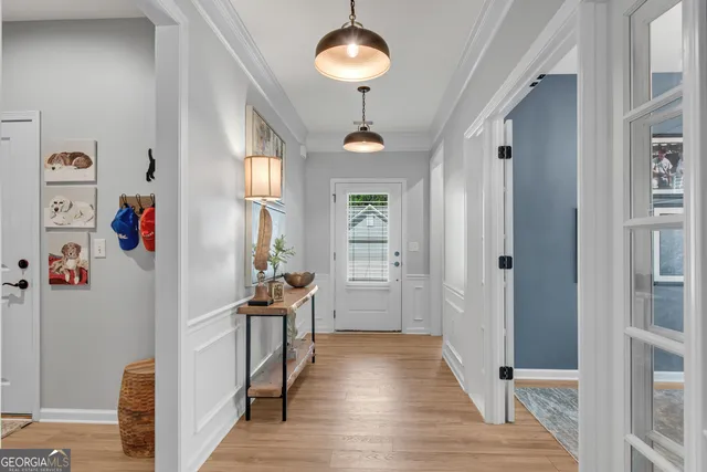 a view of a hallway with wooden floor and workspace