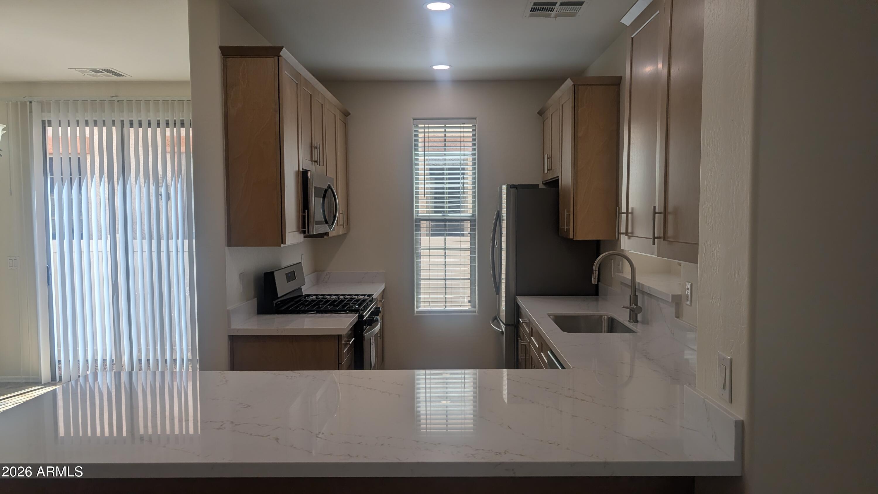 1453 South Sinova Avenue Gilbert, AZ 85296 - Photo 7 of 46 a view of a living room and bathroom