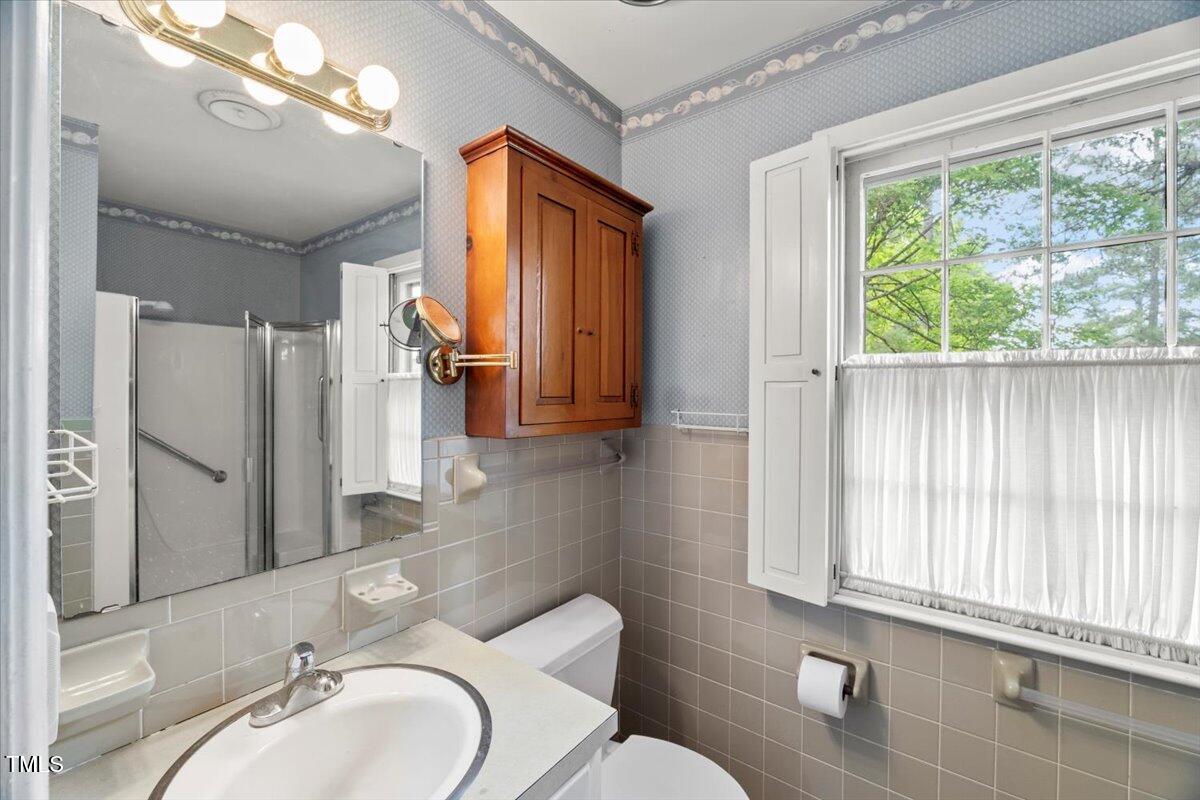 3025 Wycliff Road Raleigh, NC 27607 - Photo 26 of 40 a bathroom with a granite countertop sink toilet and shower