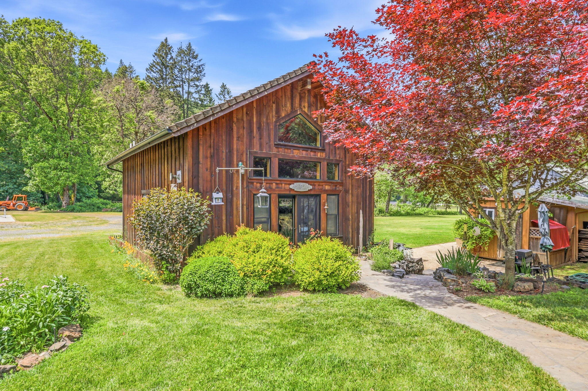 985 Elliott Creek Road Wilderville, OR 97543 - Photo 62 of 98 a view of a house with backyard and garden