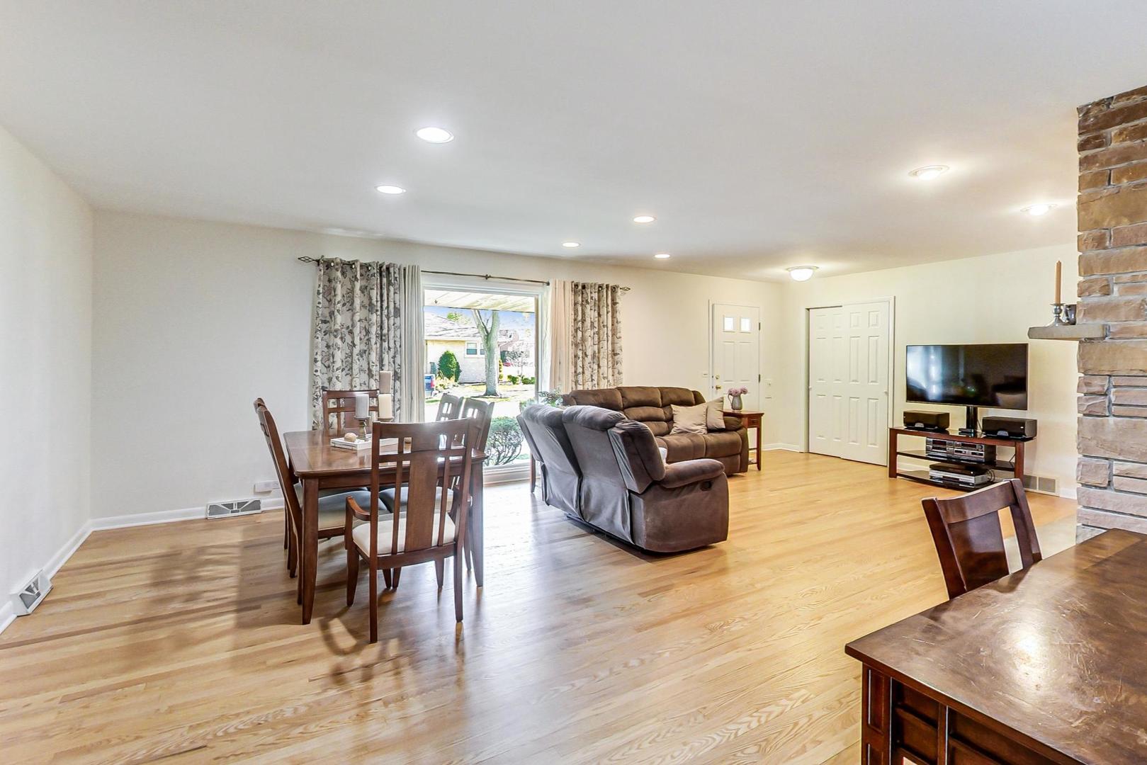 3018 Farrell Avenue Park Ridge, IL 60068 - Photo 8 of 34 a living room with furniture a flat screen tv and a dining table