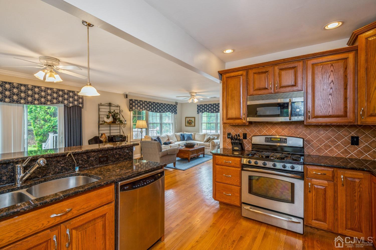 44 Chambers Road Cream Ridge, NJ 08514 - Photo 11 of 27 a kitchen with stainless steel appliances granite countertop a stove a sink and a microwave