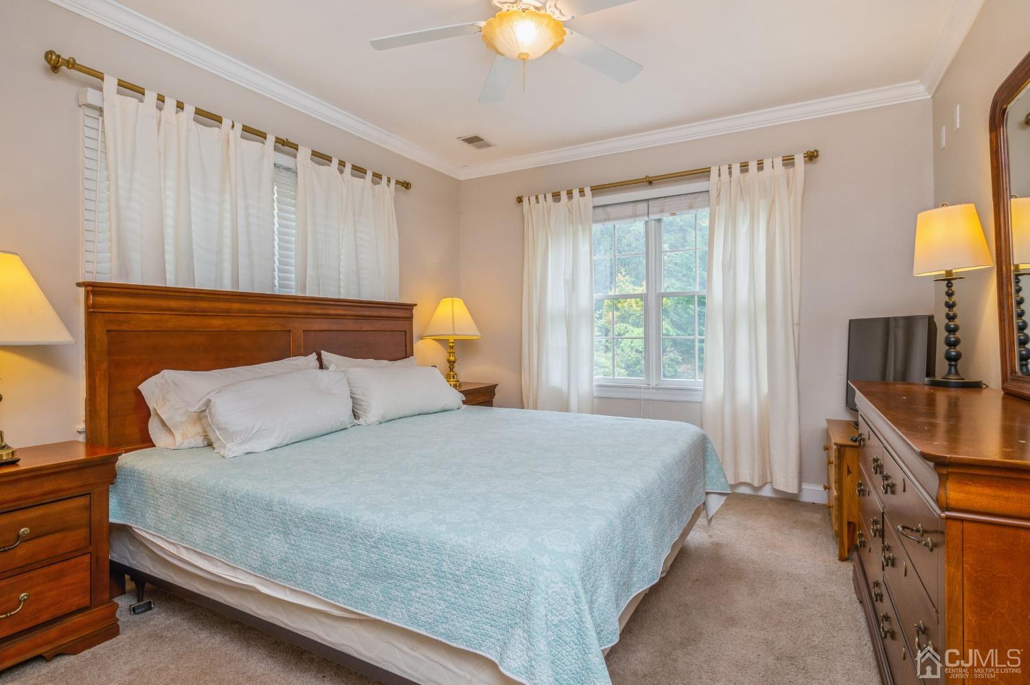 44 Chambers Road Cream Ridge, NJ 08514 - Photo 14 of 27 a bedroom with a bed and a chandelier