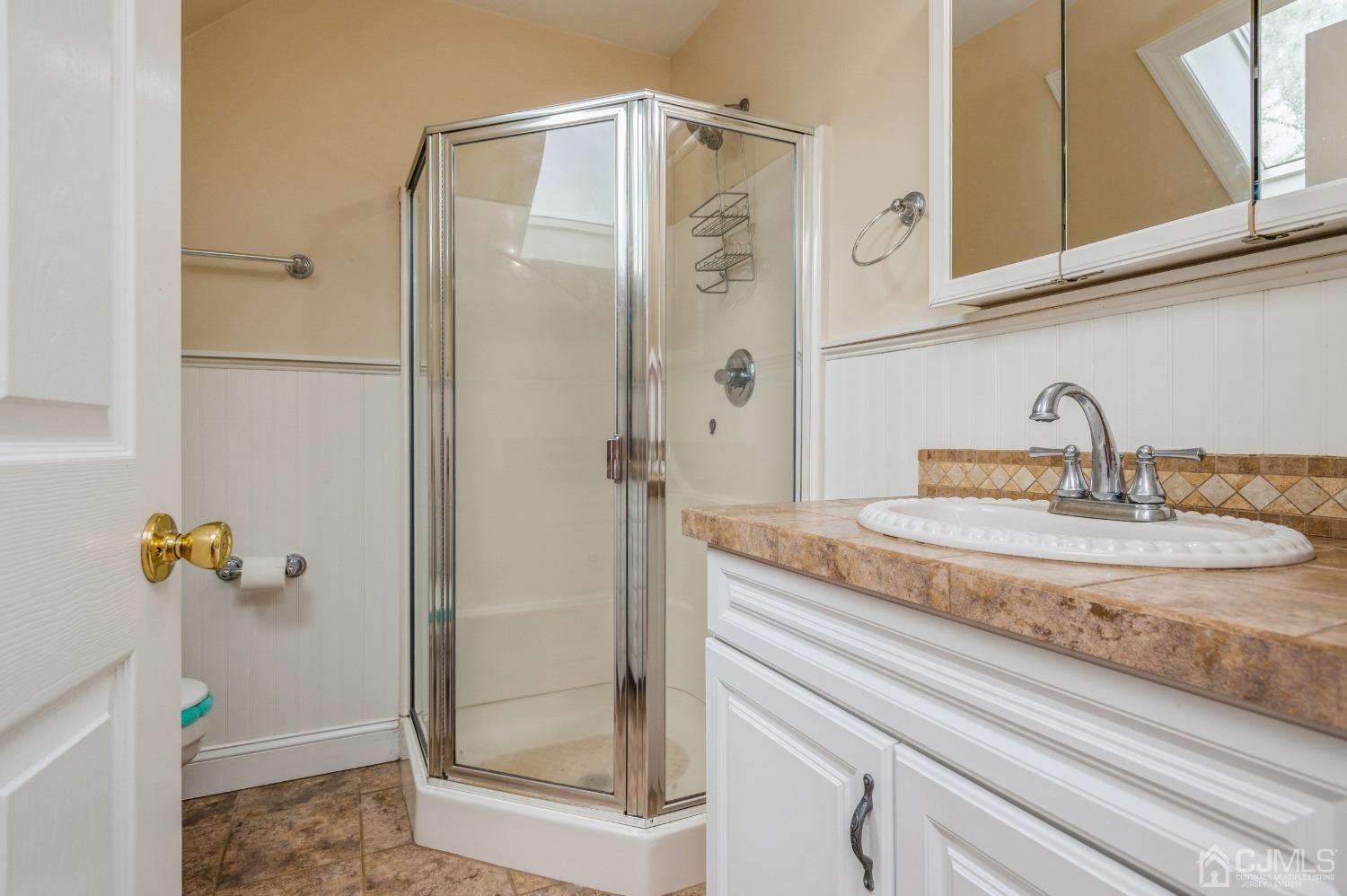 44 Chambers Road Cream Ridge, NJ 08514 - Photo 17 of 27 a bathroom with a sink a mirror and shower