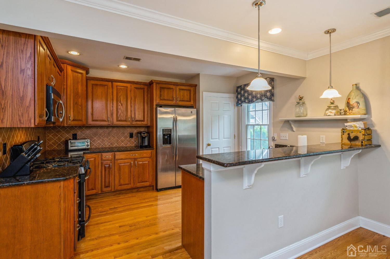 44 Chambers Road Cream Ridge, NJ 08514 - Photo 9 of 27 a kitchen with stainless steel appliances granite countertop a sink a stove and a refrigerator