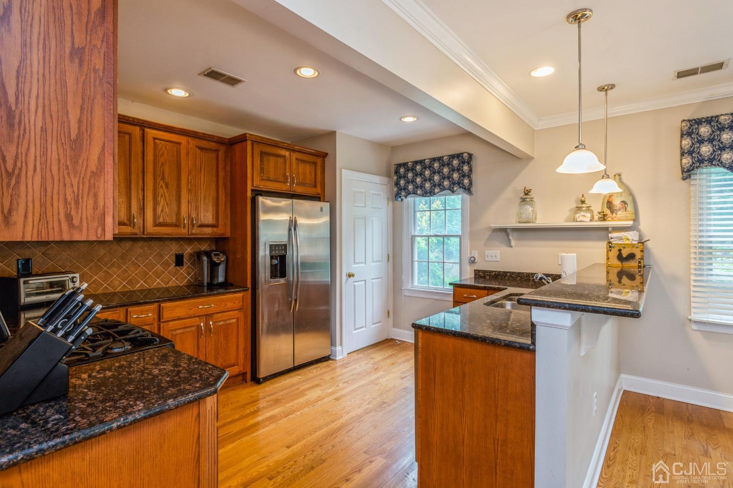 44 Chambers Road Cream Ridge, NJ 08514 - Photo 10 of 27 a large kitchen with stainless steel appliances granite countertop a stove a sink dishwasher and a refrigerator with wooden floor