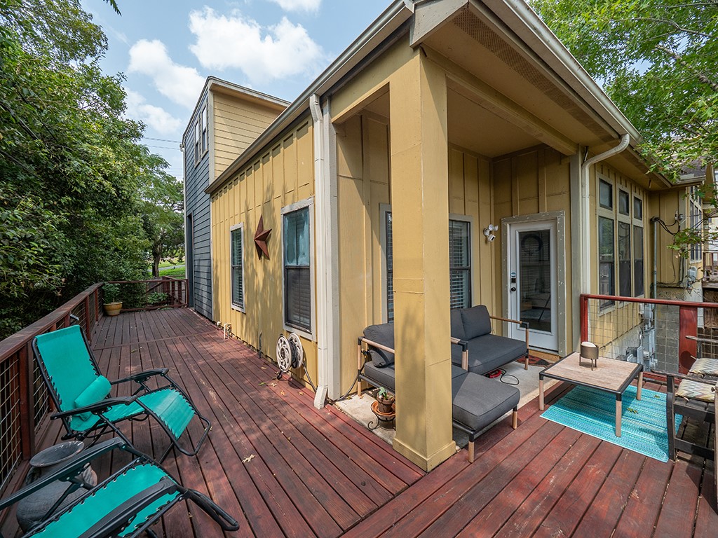 3609 Clawson Road, Unit B Austin, TX 78704 - Photo 18 of 28 Expansive wood-finish deck with metal railings and mature tree surroundings