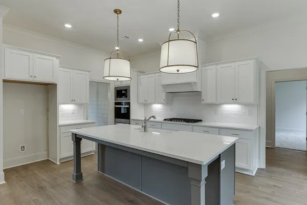 a kitchen with a sink chandelier and a fireplace
