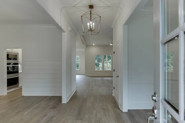 wooden floor in an empty room with a kitchen