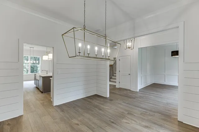 a view of a room with wooden floor fireplace and windows