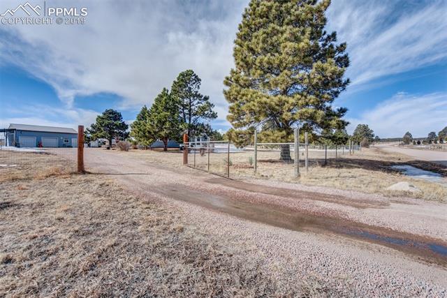 16965 Reata Road Peyton, CO 80831 - Photo 3 of 4 Auto gate and entrance to property.