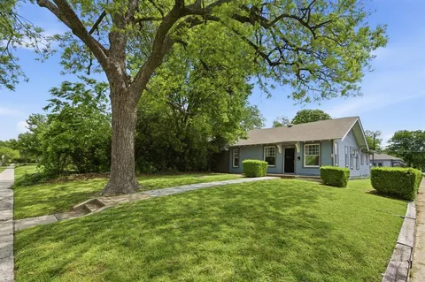a house view with a sitting space and garden