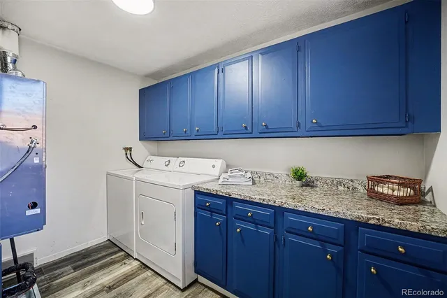 a kitchen with granite countertop wood cabinets and white appliances