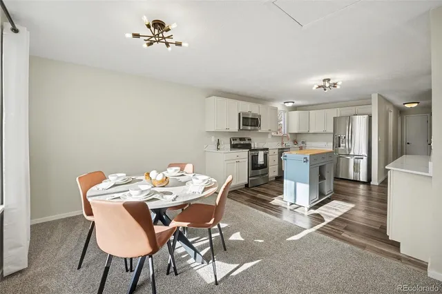a dining room with furniture a window and kitchen view
