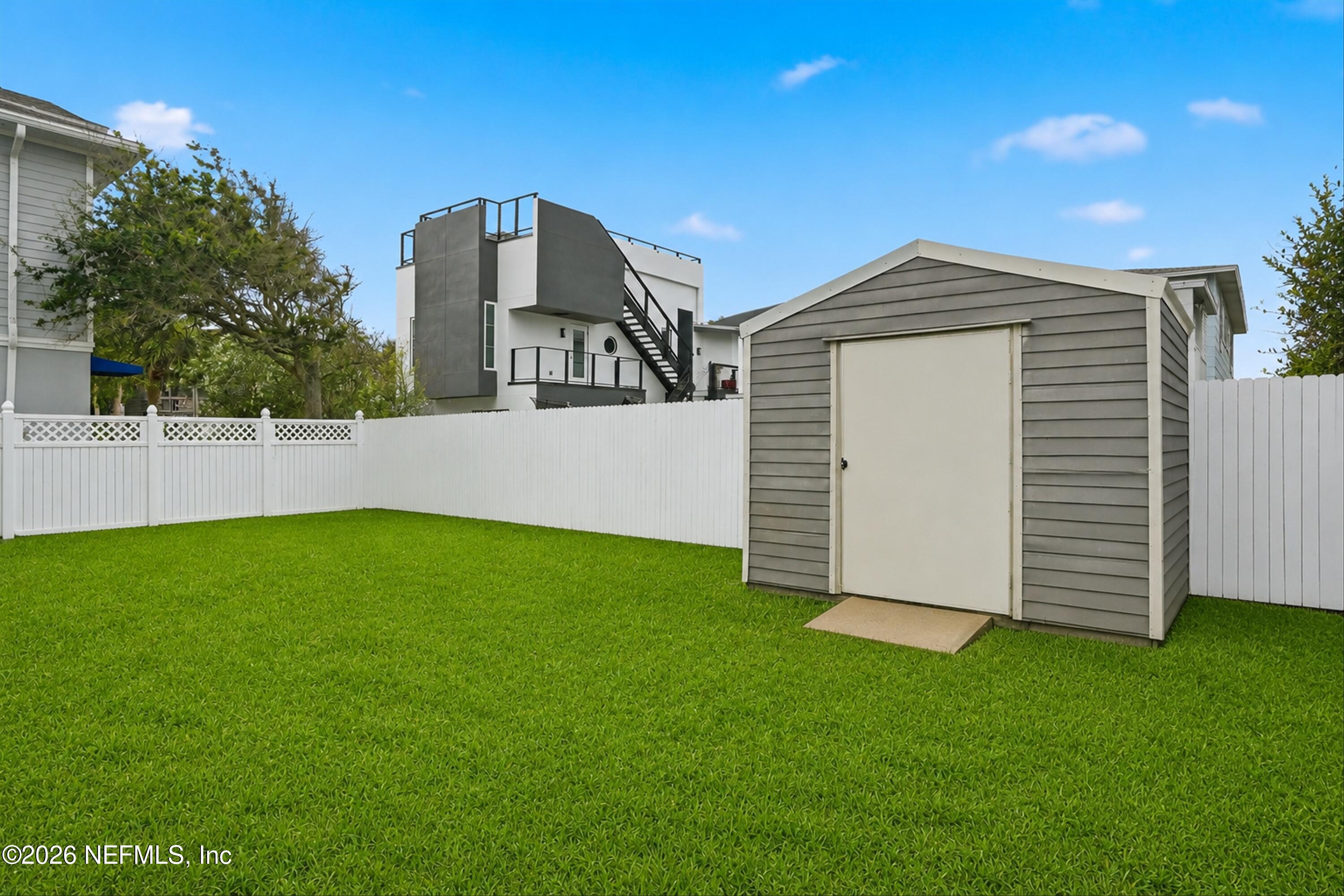 124 Hopkins Street Neptune Beach, FL 32266 - Photo 28 of 44 a view of a house with a backyard