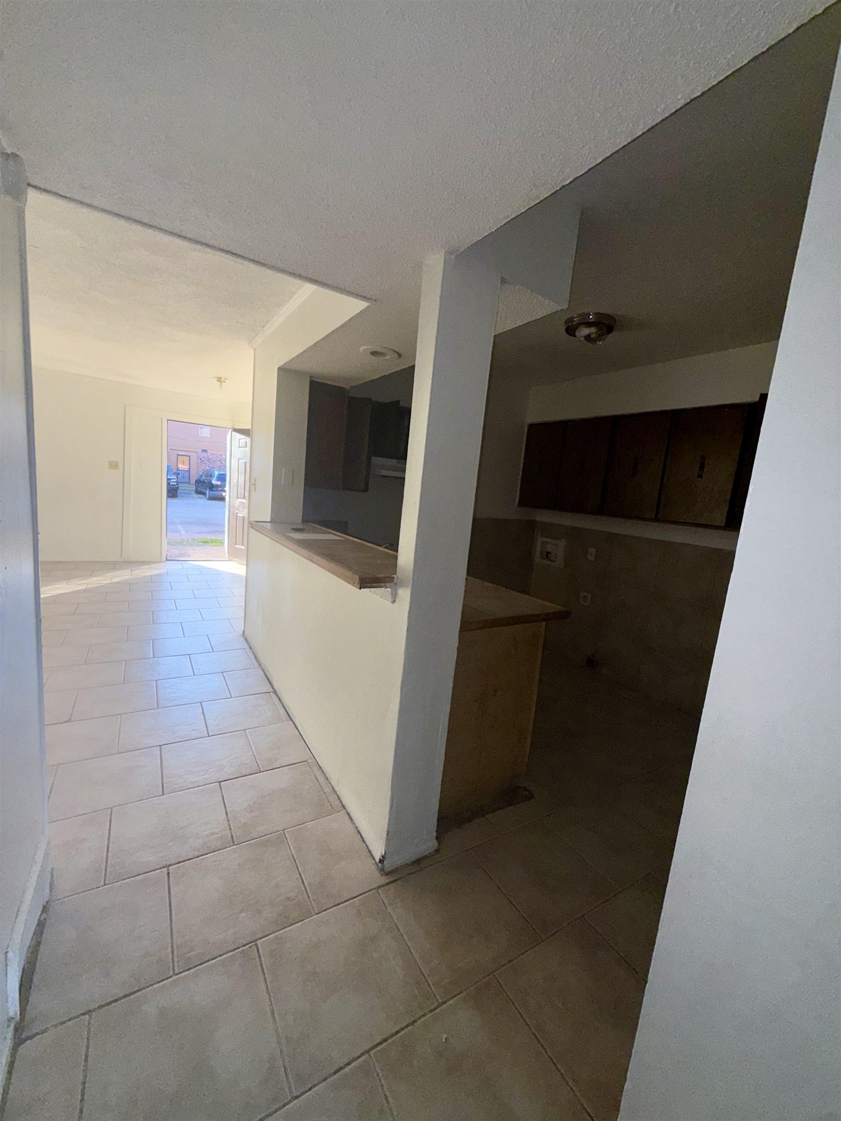 3091 Range Line Road Memphis, TN 38127 - Photo 4 of 13 Hall with light tile patterned flooring and a textured ceiling