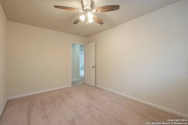 a view of a house with backyard and a tree