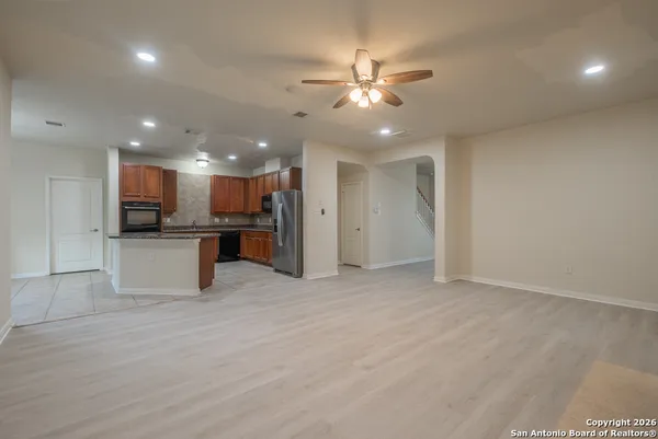 a view of a kitchen with a sink and stainless steel appliances
