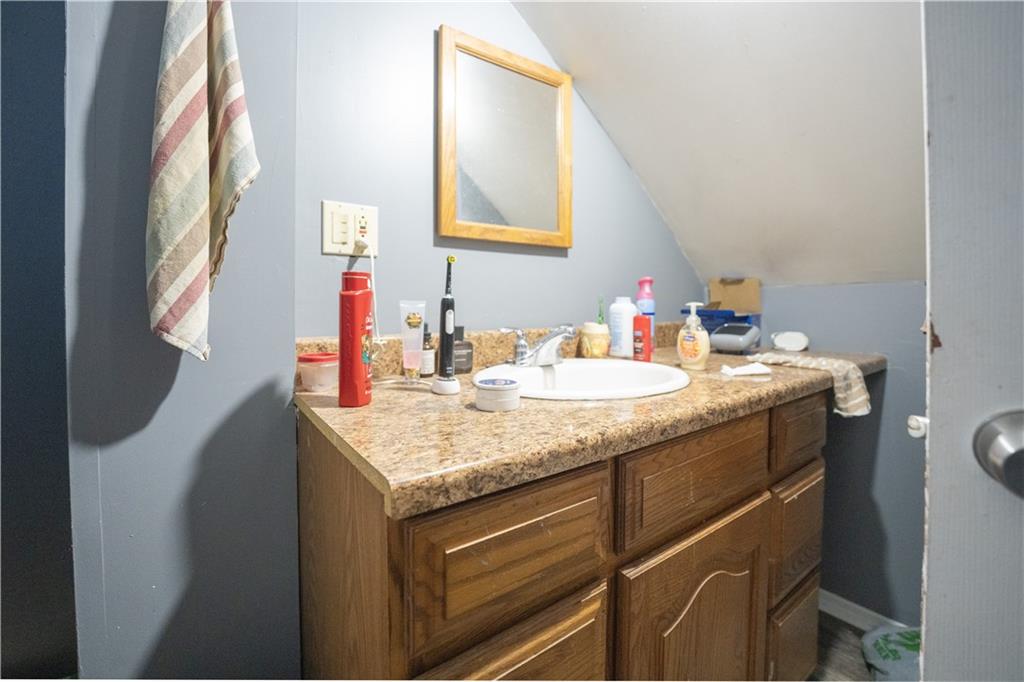881 Lenz Avenue Ambridge, PA 15003 - Photo 11 of 30 a bathroom with a granite countertop sink and a mirror