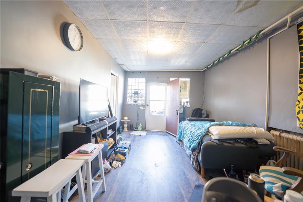 881 Lenz Avenue Ambridge, PA 15003 - Photo 5 of 30 a bedroom with furniture and a wooden floor