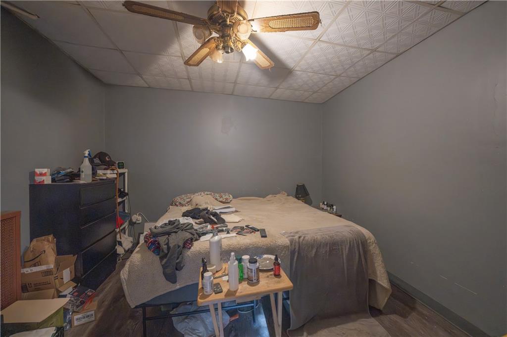 881 Lenz Avenue Ambridge, PA 15003 - Photo 9 of 30 a bedroom with a bed and a chandelier fan