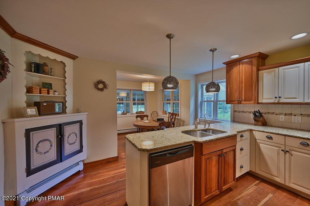 259 Hay Road Stroudsburg, PA 18360 - Photo 29 of 137 a kitchen with stainless steel appliances granite countertop a sink a stove and a wooden floors