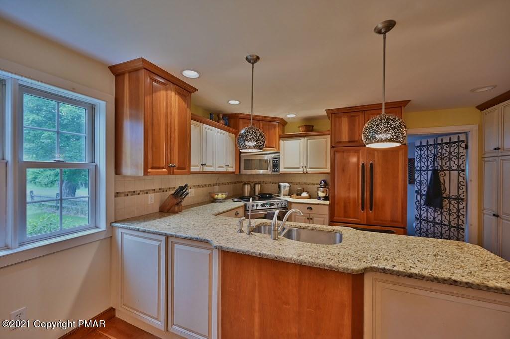 259 Hay Road Stroudsburg, PA 18360 - Photo 33 of 137 a kitchen with kitchen island granite countertop a sink a counter top space and cabinets