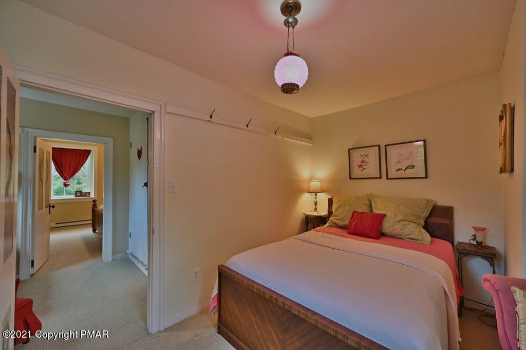 259 Hay Road Stroudsburg, PA 18360 - Photo 49 of 137 a bedroom with a bed and a painting on the wall