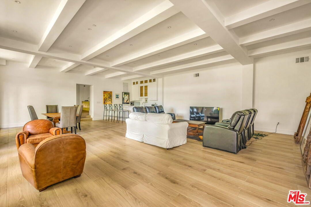 9669 Oak Pass Road Beverly Hills, CA 90210 - Photo 27 of 37 a living room with furniture and a wooden floor