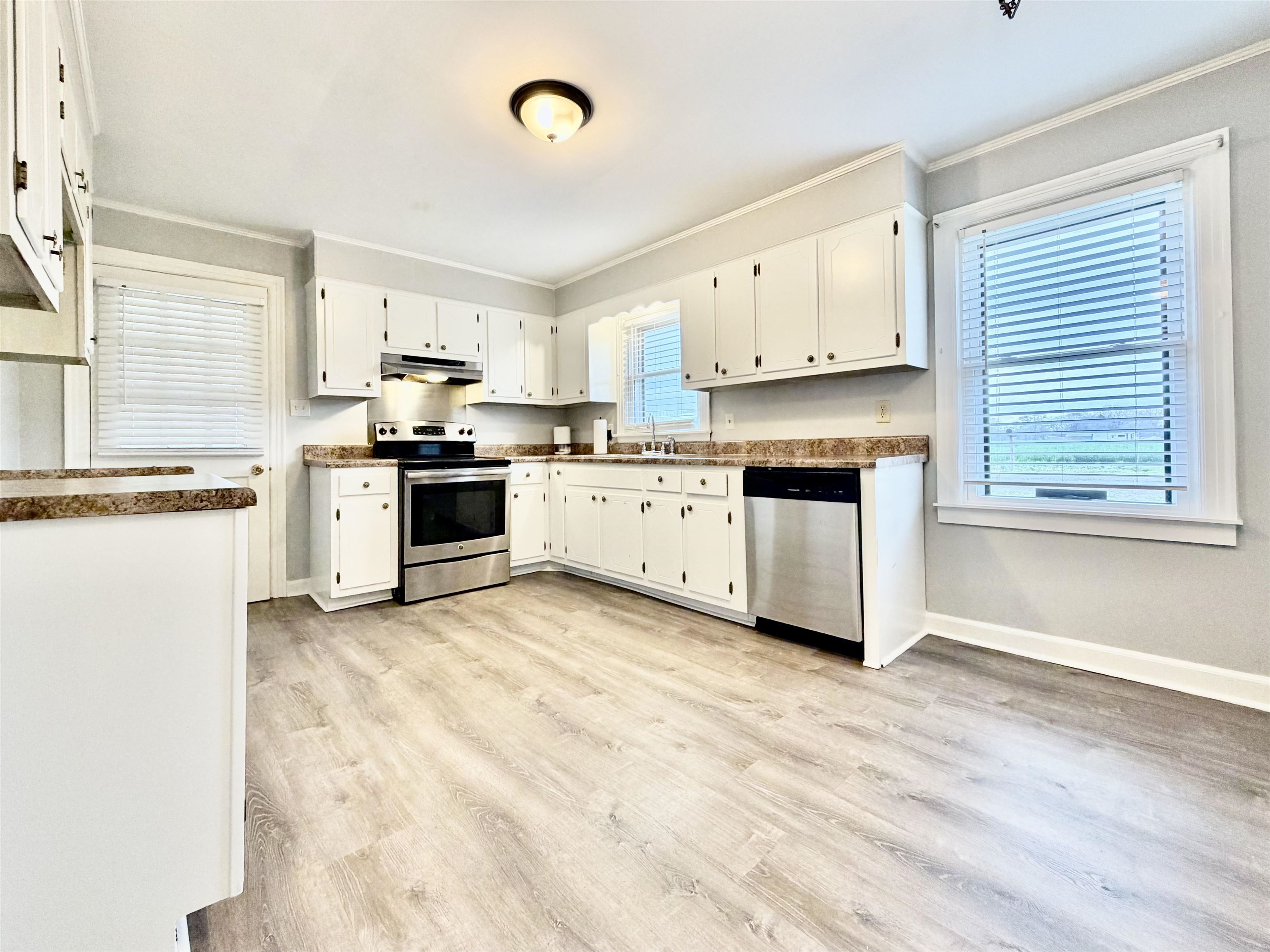 5442 Bride Road Covington, TN 38019 - Photo 9 of 20 a kitchen with stainless steel appliances granite countertop a stove top oven sink and cabinets
