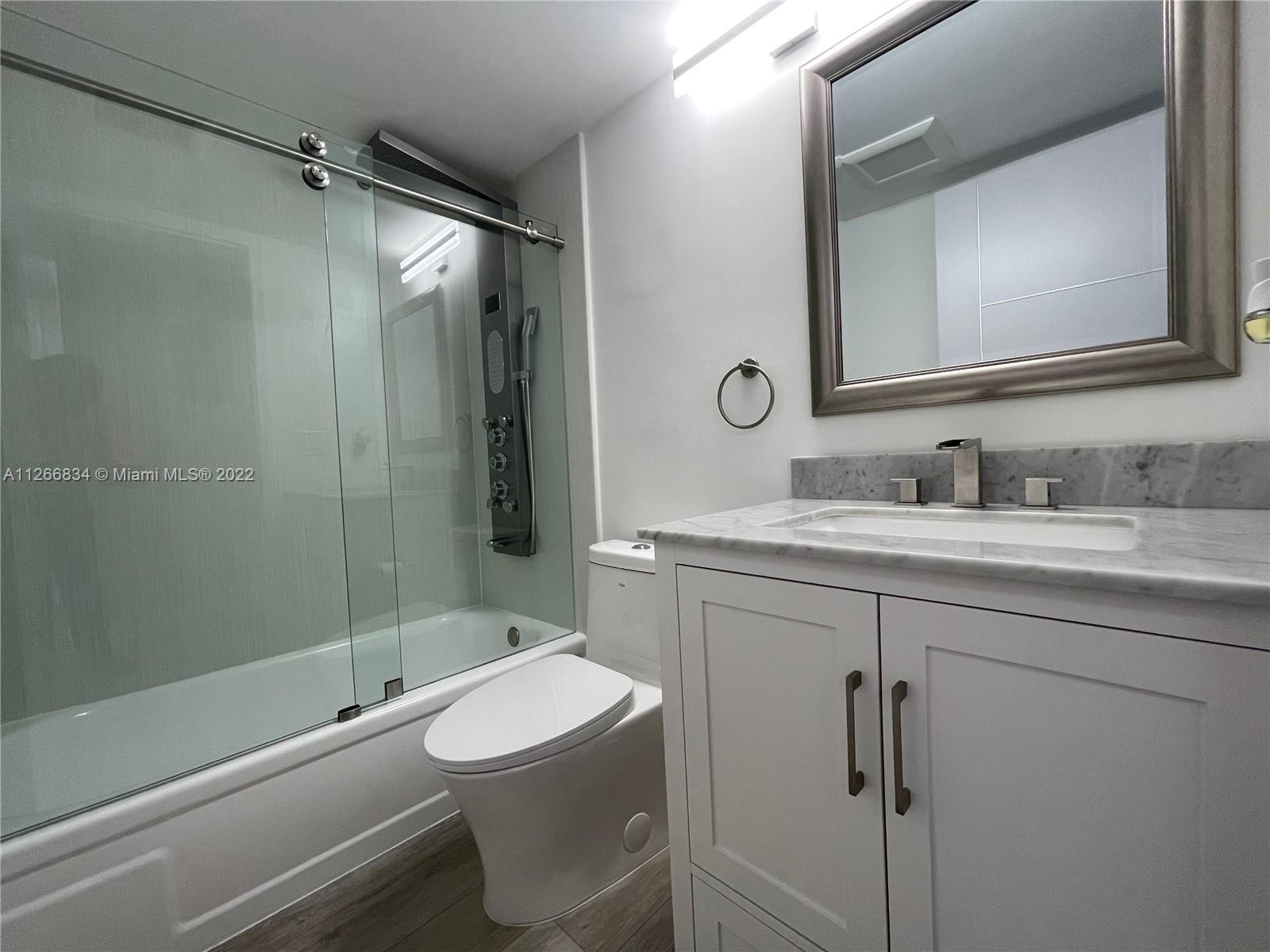 1084 Guildford East Boca Raton, FL 33434 - Photo 17 of 34 a bathroom with a sink toilet and shower