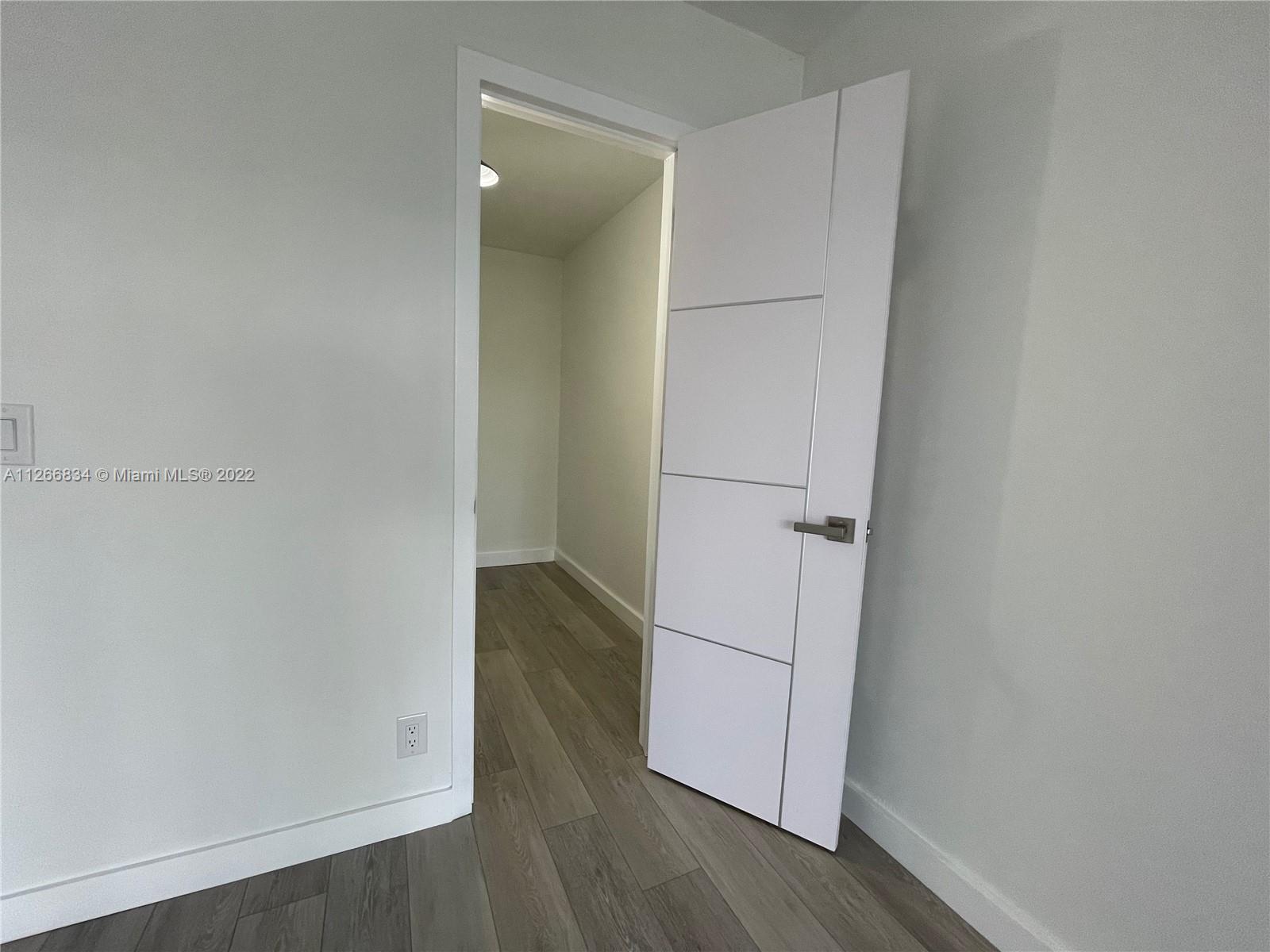 1084 Guildford East Boca Raton, FL 33434 - Photo 20 of 34 an empty room with wooden floor