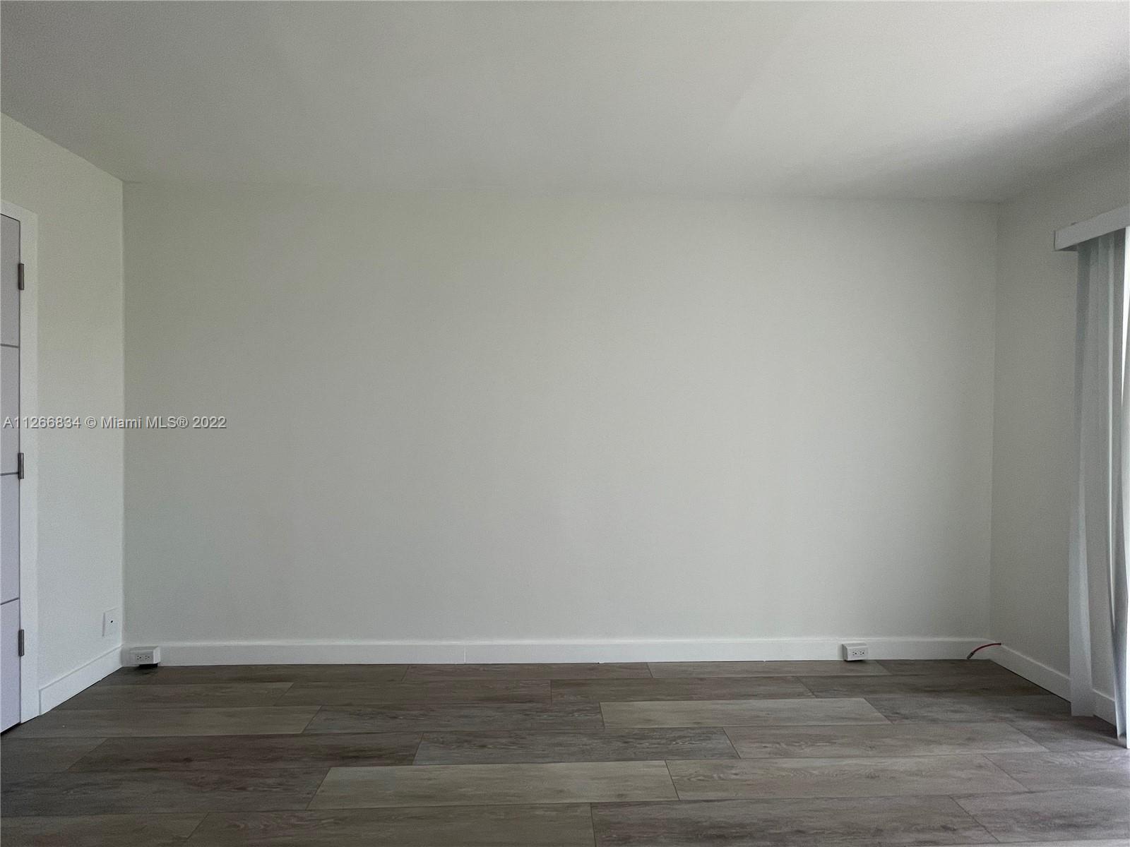 1084 Guildford East Boca Raton, FL 33434 - Photo 23 of 34 a view of an empty room and wooden floor