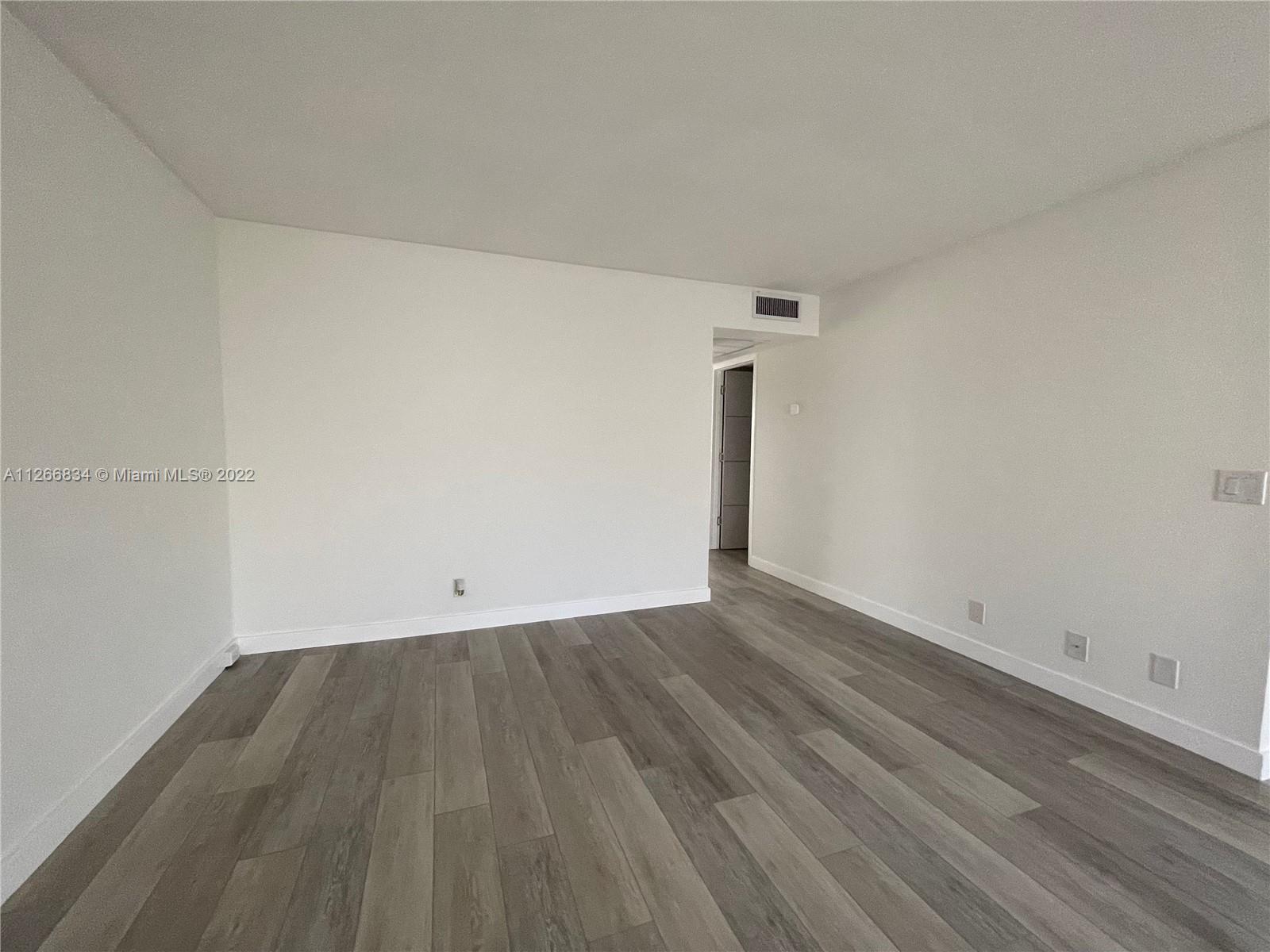 1084 Guildford East Boca Raton, FL 33434 - Photo 26 of 34 a view of an empty room with wooden floor
