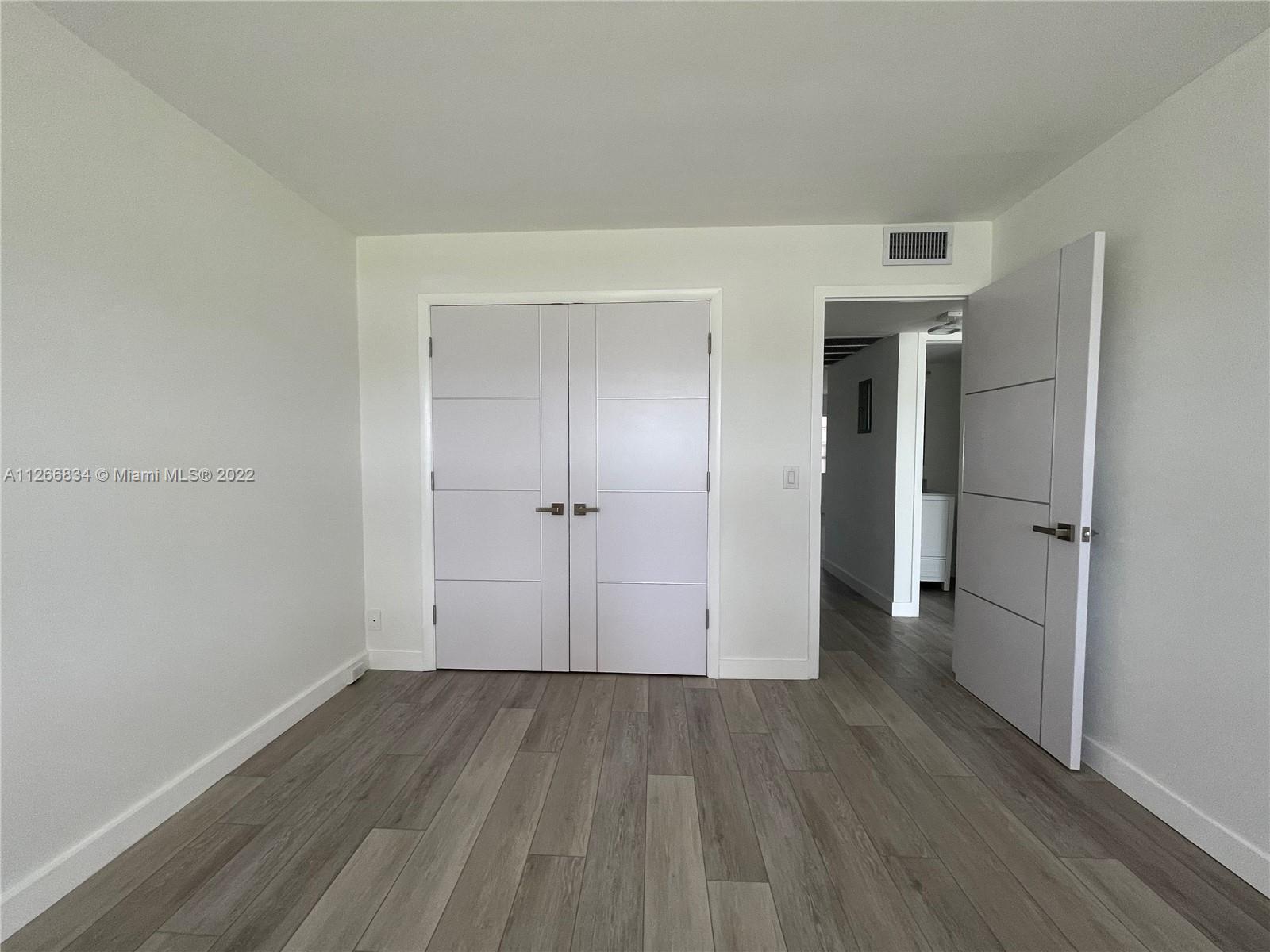 1084 Guildford East Boca Raton, FL 33434 - Photo 29 of 34 a view of a room with wooden floor